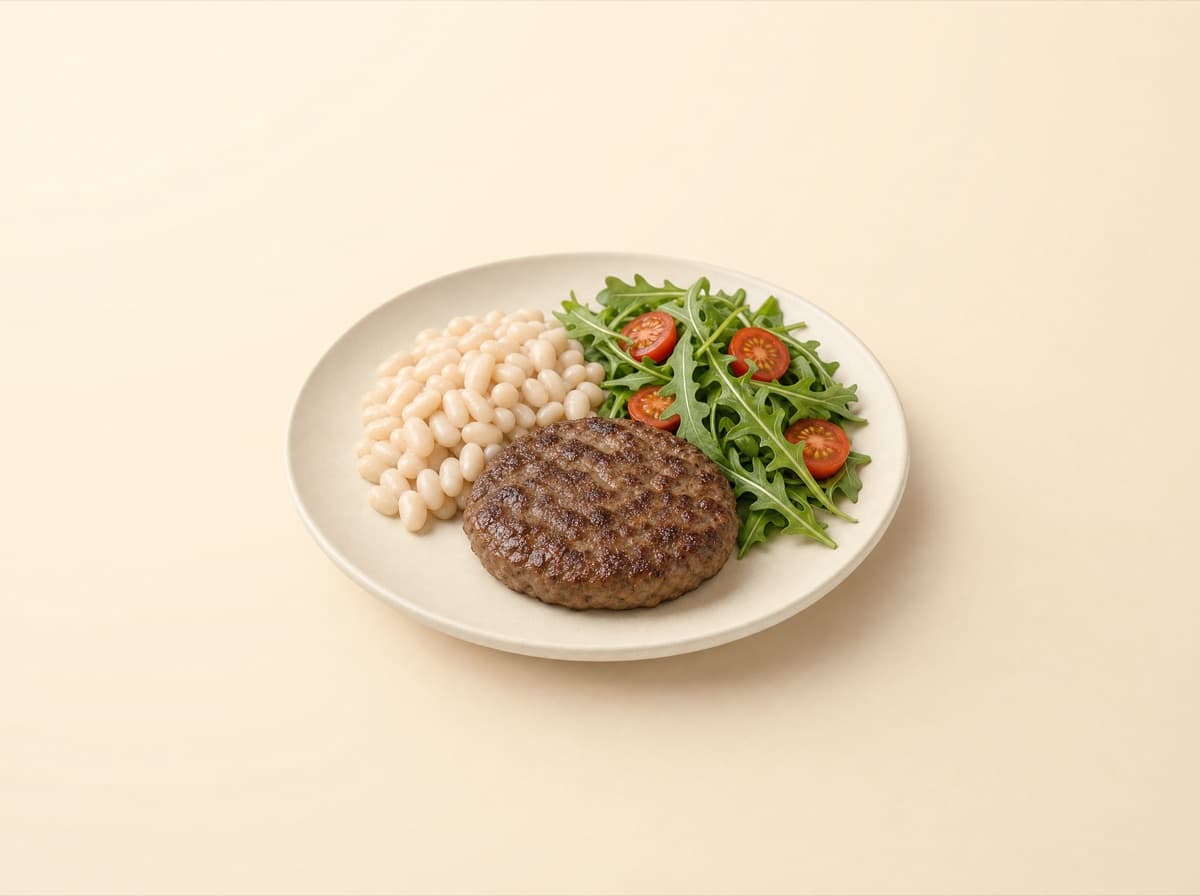 The plate: beef patty with white beans and arugula.