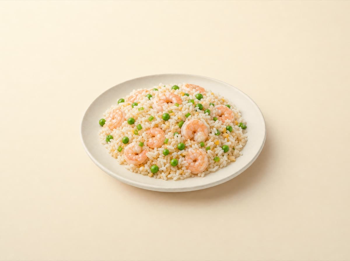 The plate: fried rice with shrimp and peas.